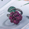 Geometric black gold ring with red simulated corundum centrepiece in flower design