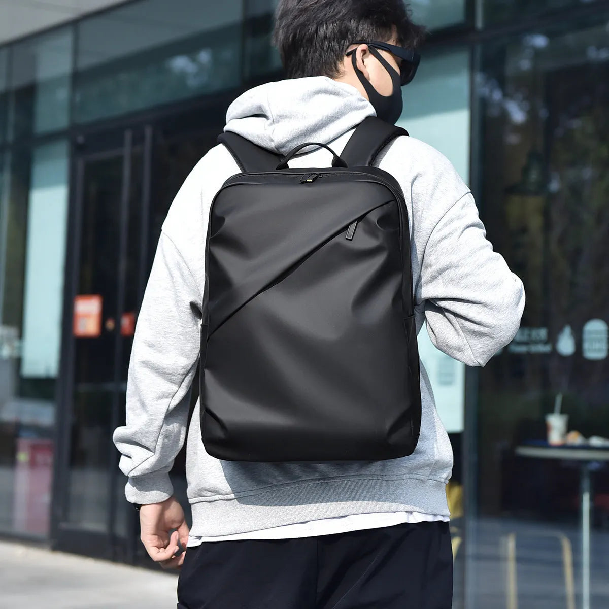 Large waterproof PU leather backpack for men in black, shown with computer compartment