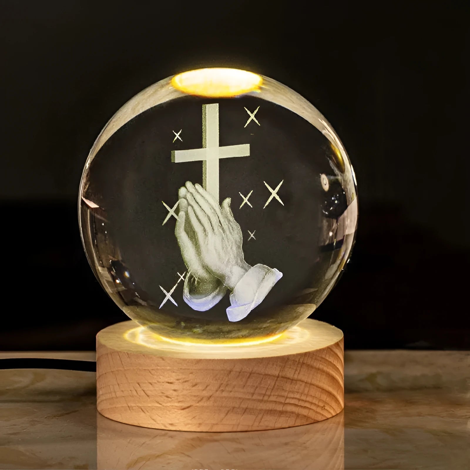 6cm white crystal ball ornament with engraved cross on a solid wood warm light base.