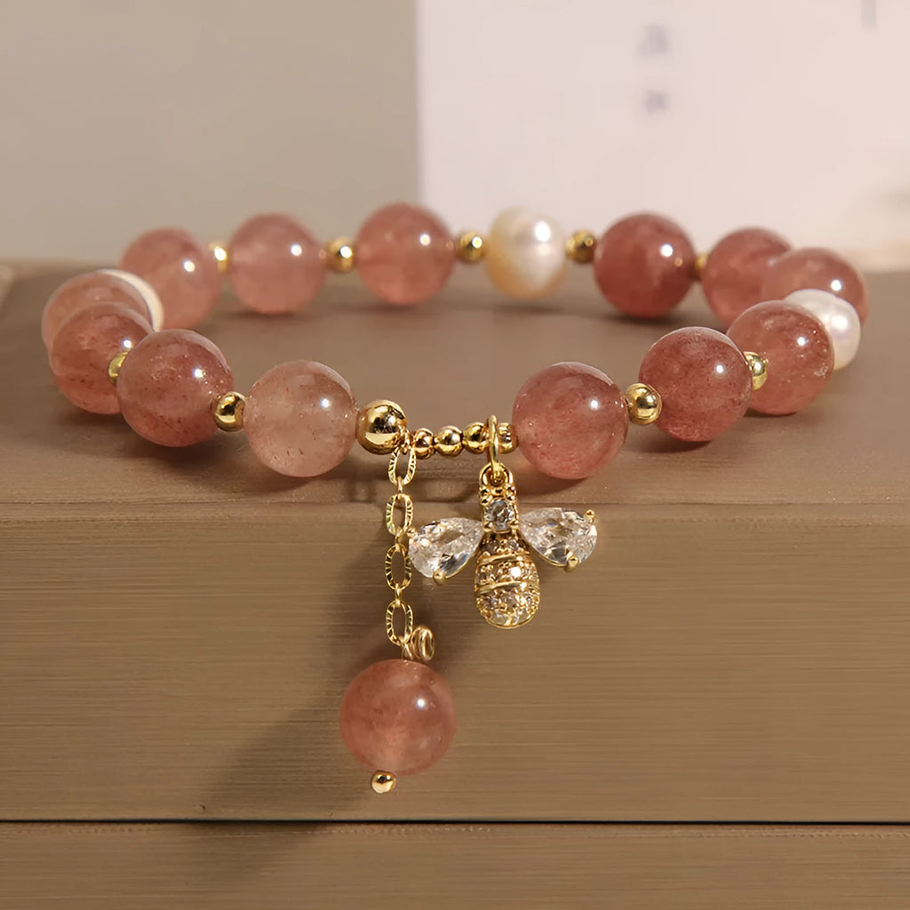 Women's bracelet with strawberry quartz beads, freshwater pearls, and metallic charms in Japanese Korean jewellery style