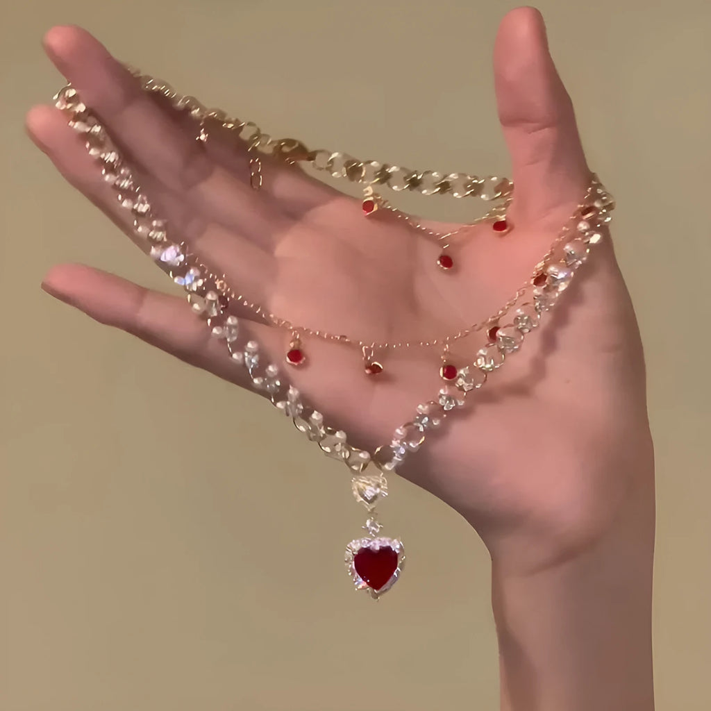 Red love heart and pearl charm on a double-layer adjustable alloy necklace.