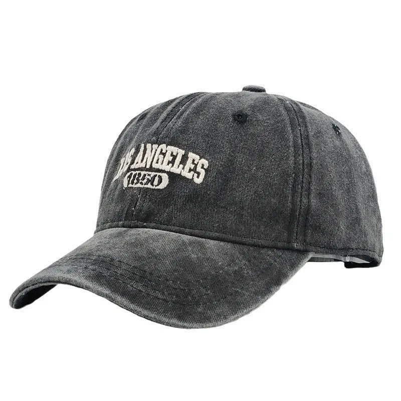 Adult personalised peaked cap with embroidered vintage letters, shown in beige colour.