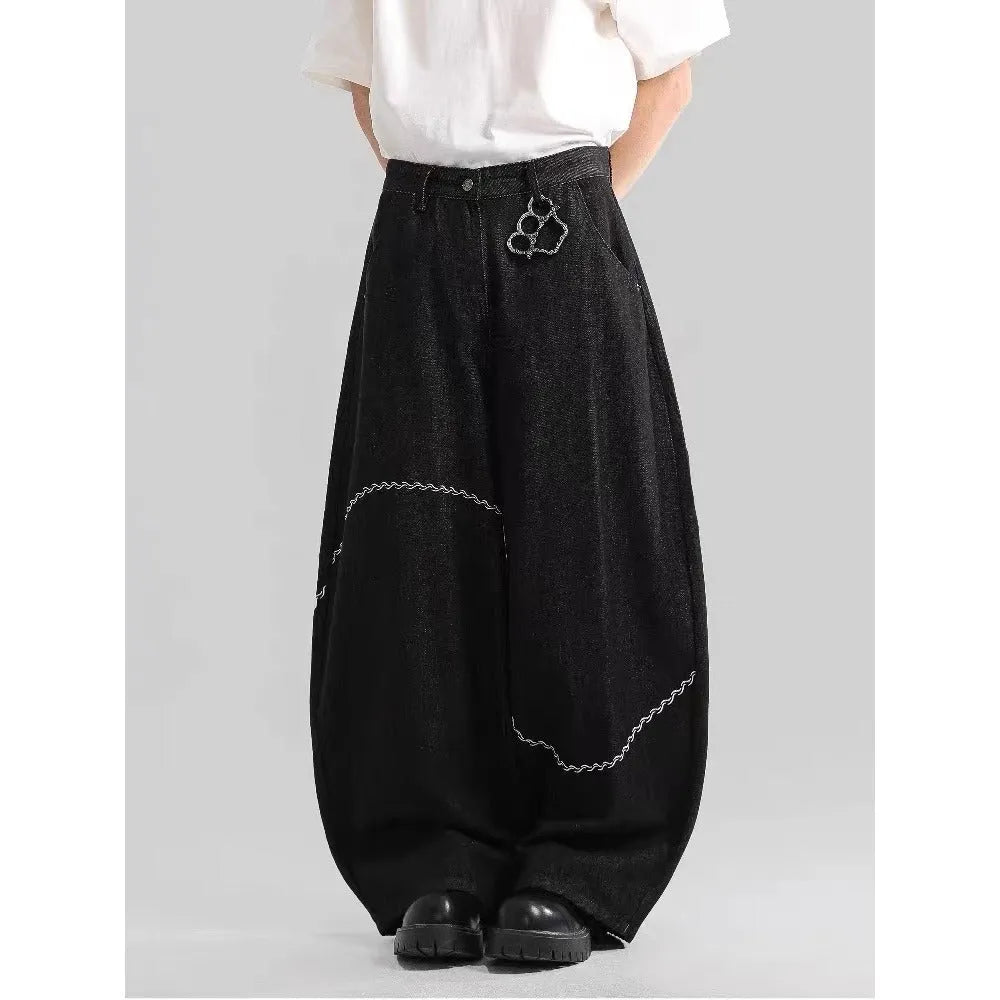 Black straight-leg denim trousers with a mid-waist fit and zip fly, laid flat.