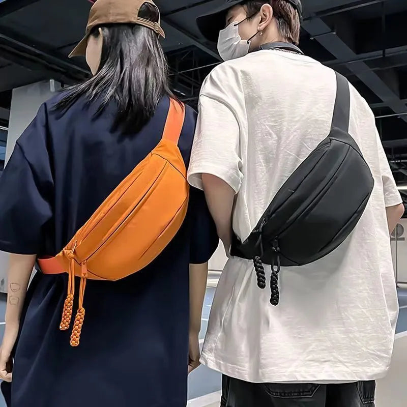 Men's black crossbody chest bag with adjustable shoulder strap showing front compartment