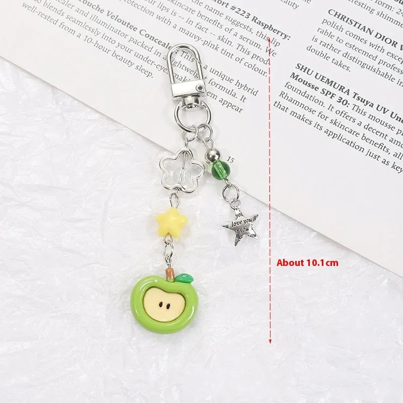 Mobile phone charm keychain with fruit designs including apple and strawberry patterns