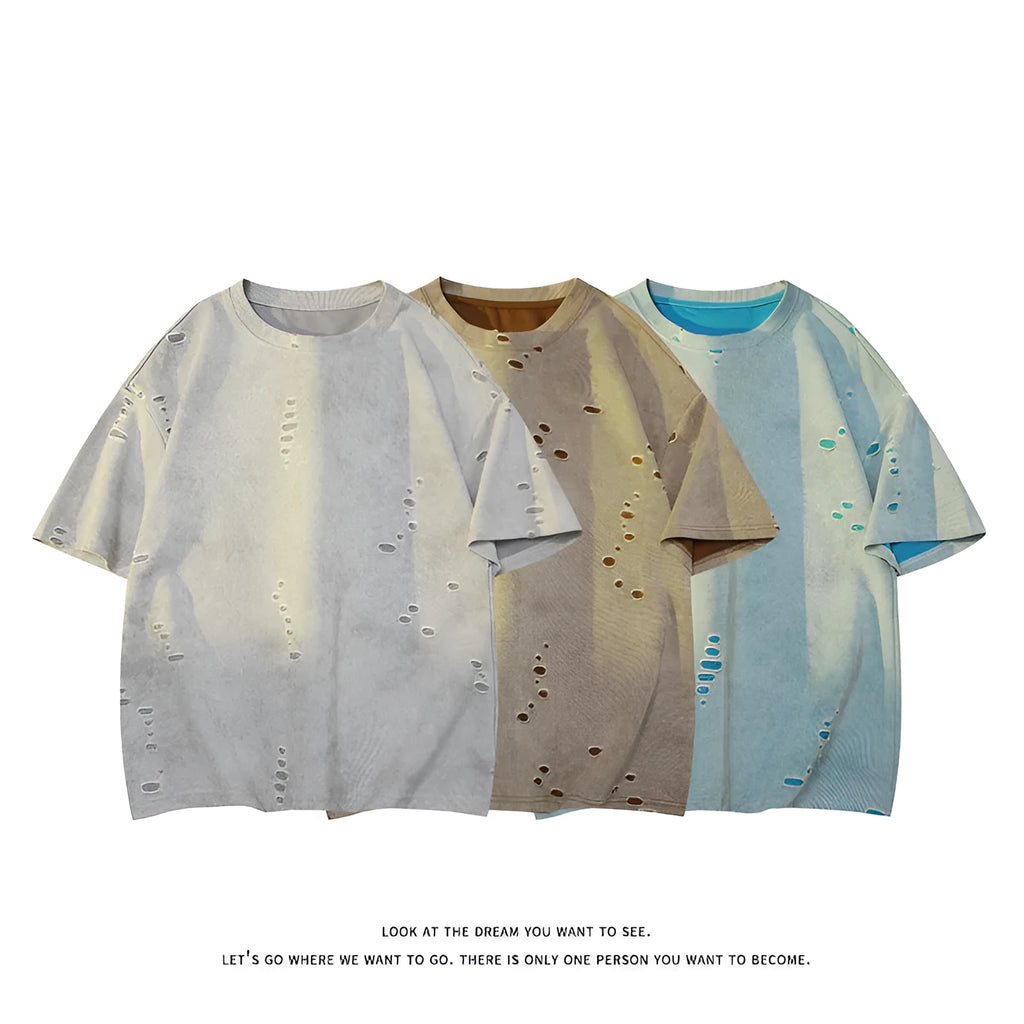 Man wearing a loose fit blue cotton blend T-shirt with ripped detail on the sleeve.