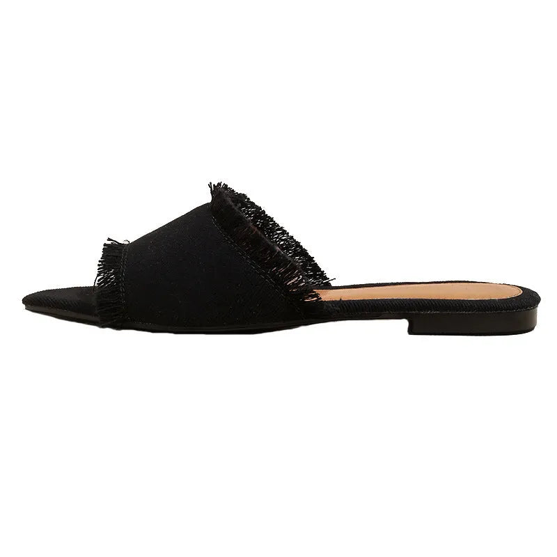 Women's denim slippers with leather lining, tassel detail, and a lightweight PVC sole.