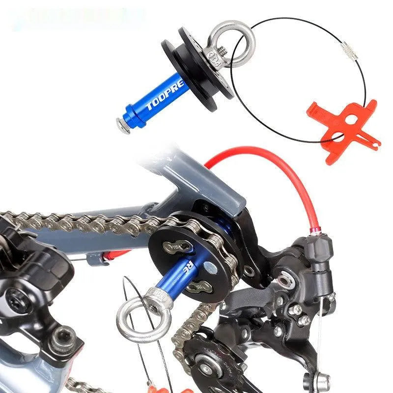 Aluminium bicycle chain holder tool for washing and tension measurement on a workbench.