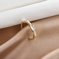 Gold alloy ring with square artificial gemstone inlay and diamond-cut surface, adjustable opening, on a white background