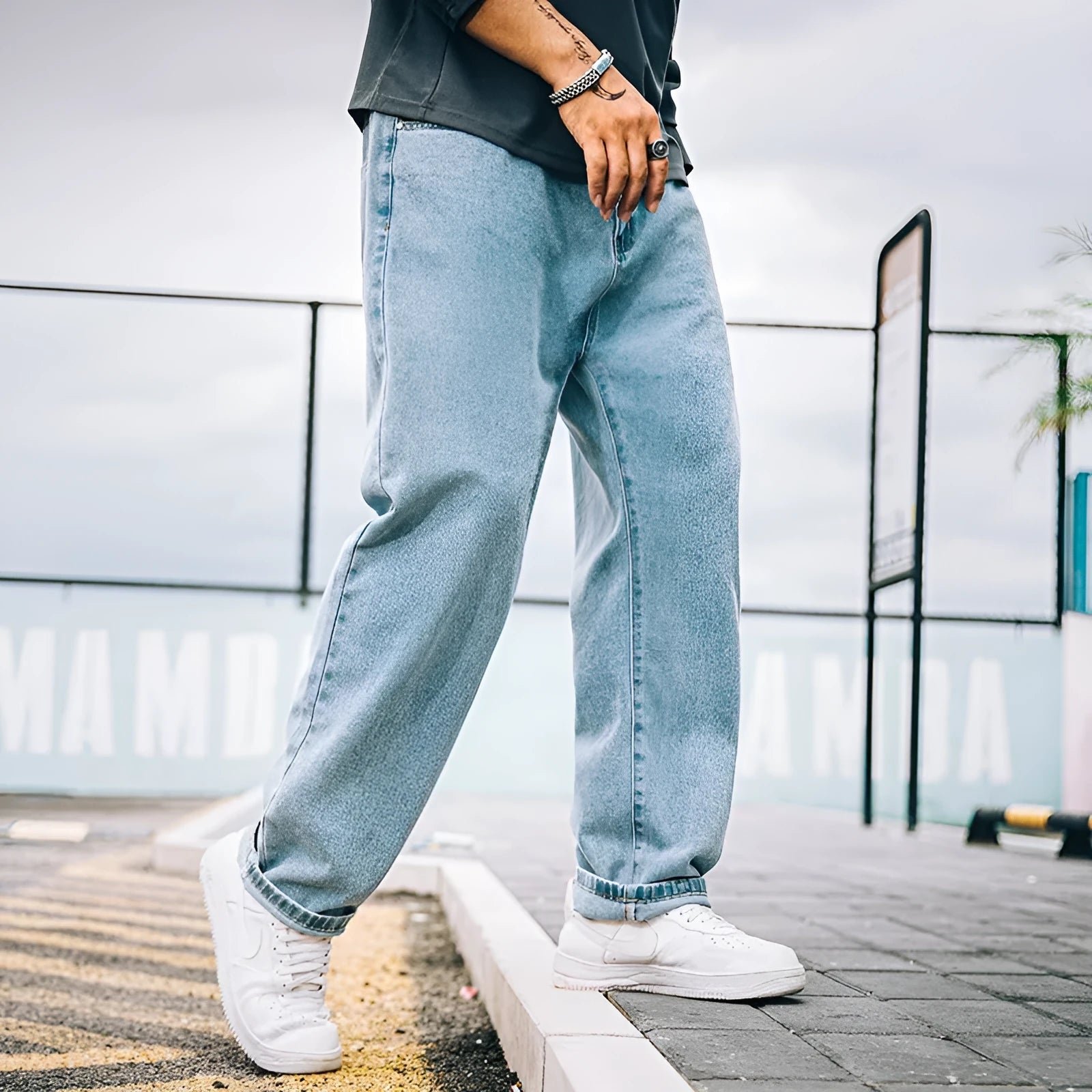 Men's loose straight cotton jeans in dark blue colour showing mid waist and zipper fly design