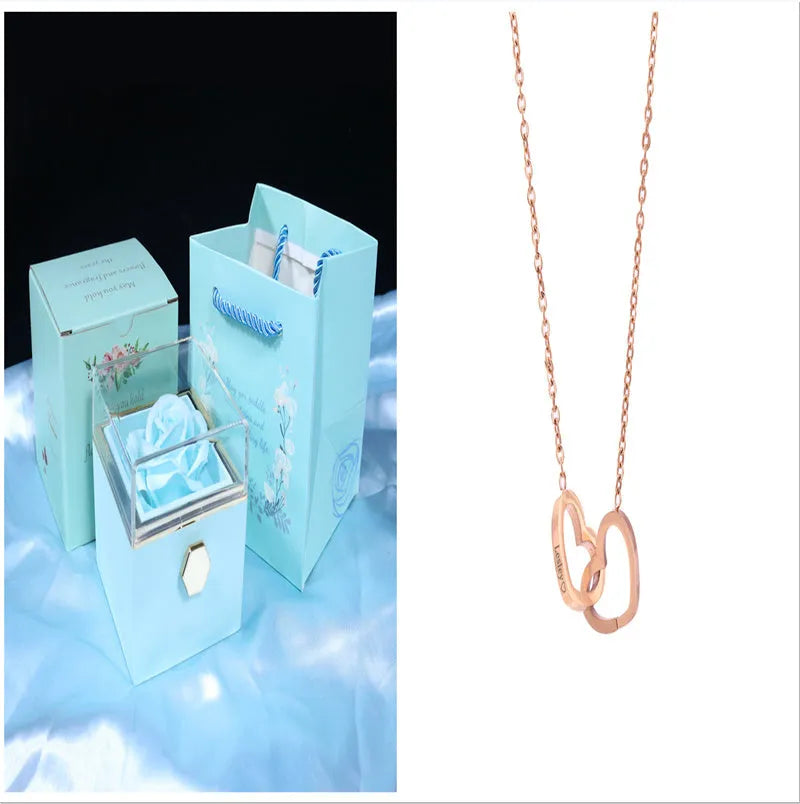 Rotating rose jewellery gift box with acrylic transparent cover showing preserved rose and rotating drawer open.