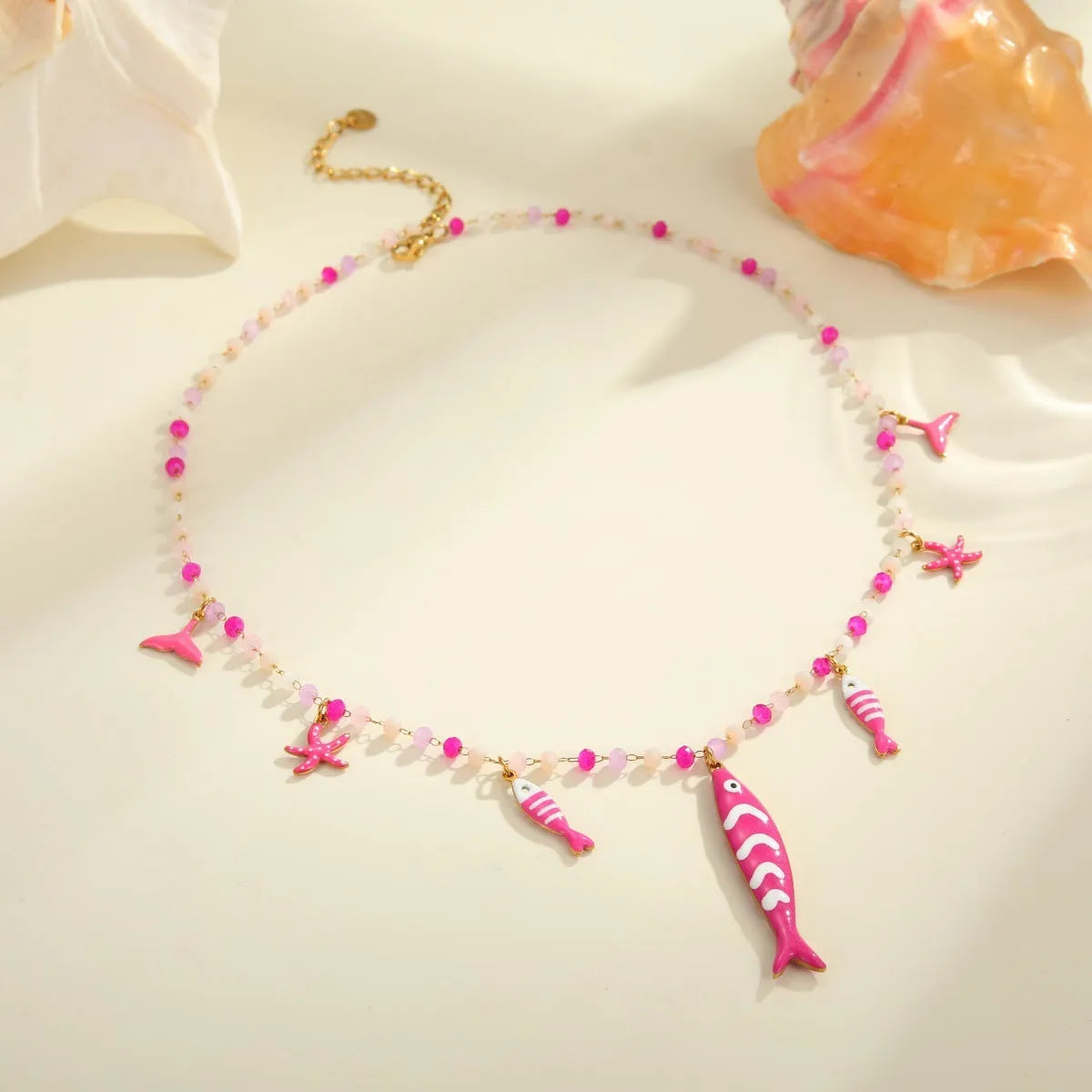 Stainless steel pendant necklace with oil drip beads, starfish design, 18K finish in pink colour, adjustable chain