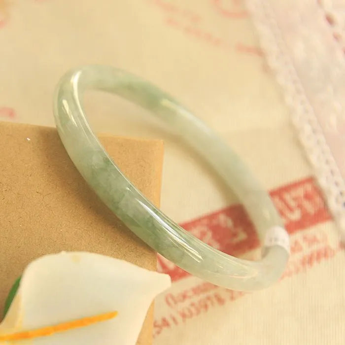 Green jade waxy Chinese style bracelet with geometric pattern showing 10mm width and adjustable sizing
