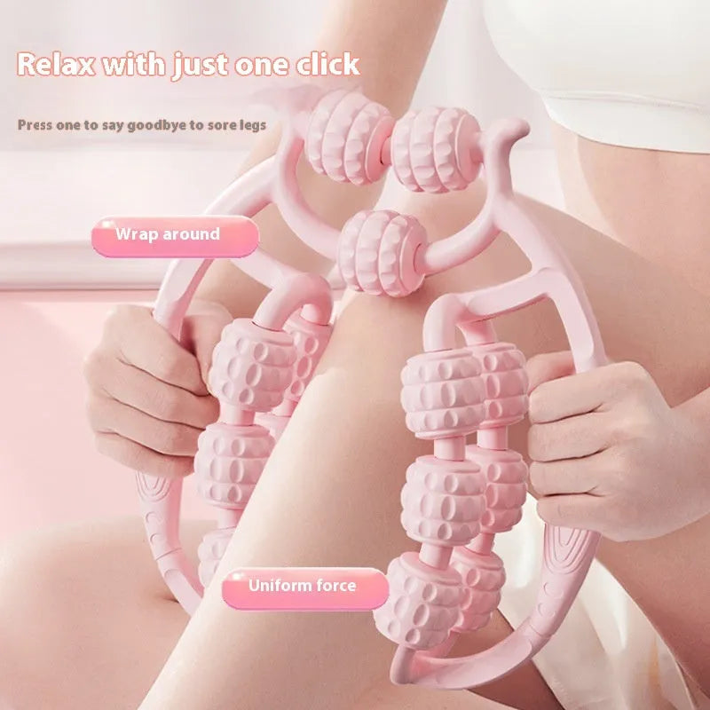 Ring clip leg roller massage tool with double-row wheels in coral pink on a leg.