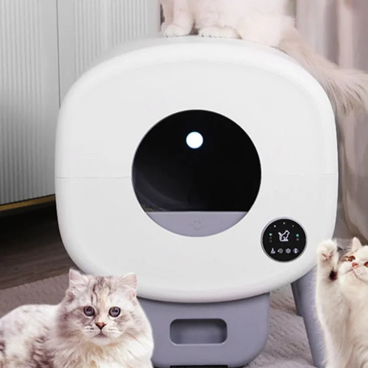 Automatic self-cleaning cat litter box made from white ABS plastic with a cleaning brush and tablets.