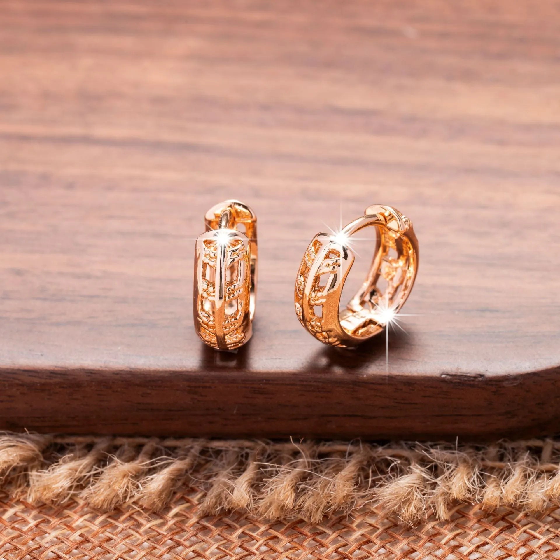 Small copper earrings with hollowed-out leaf and heart shapes, rose gold plated.
