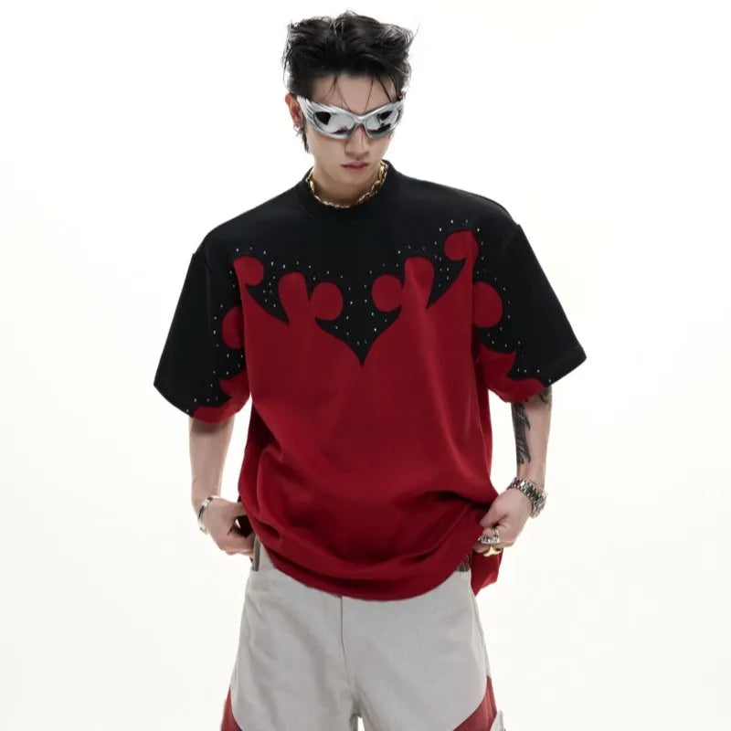 Men's grey cotton T-shirt with burnt flower stitching and rhinestone details on the front, showing loose fit and drop-shoulder sleeves.