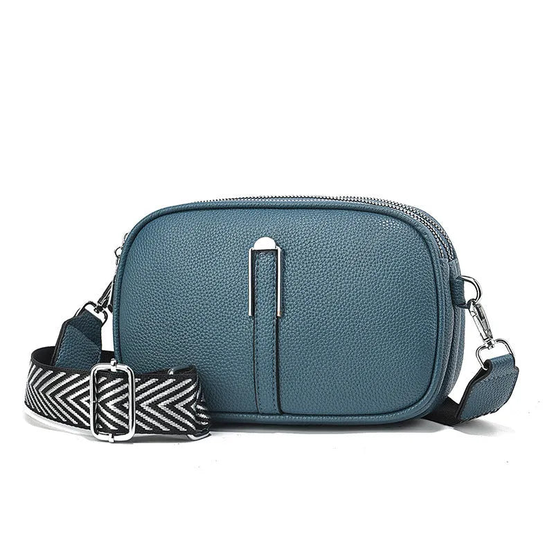 Women's soft PU crossbody bag in oval shape with multiple internal compartments and slit pocket
