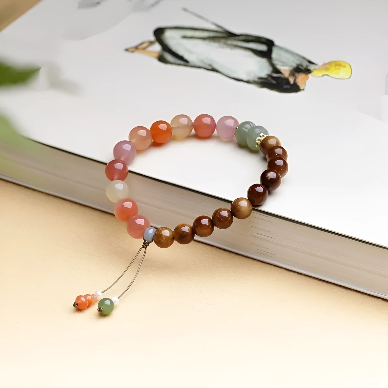 Women's agate bracelet with 8mm diamond-shaped persimmon-coloured beads on a wrist.