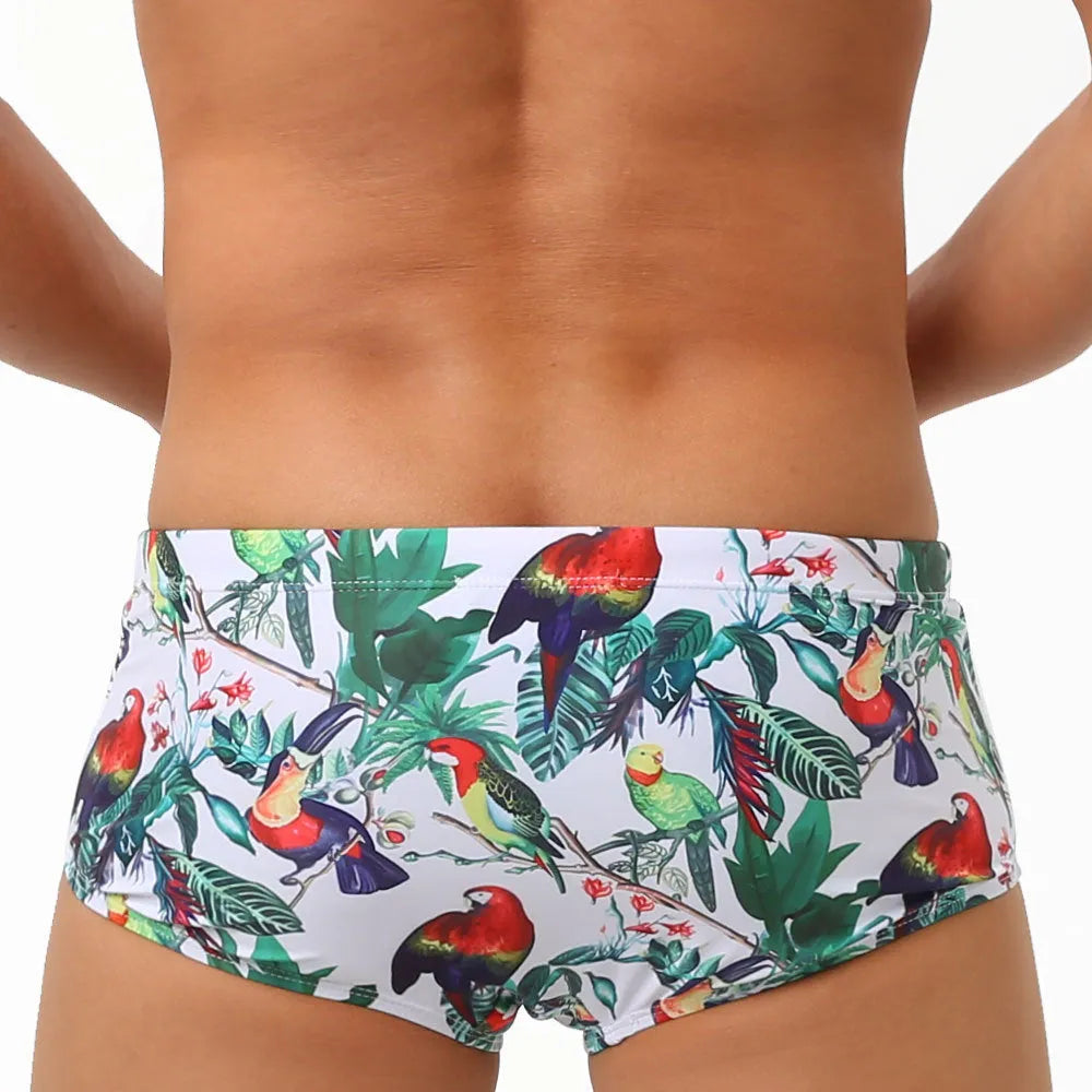 Men's swimming trunks with flower-bird print pattern in nylon fabric showing briefs style