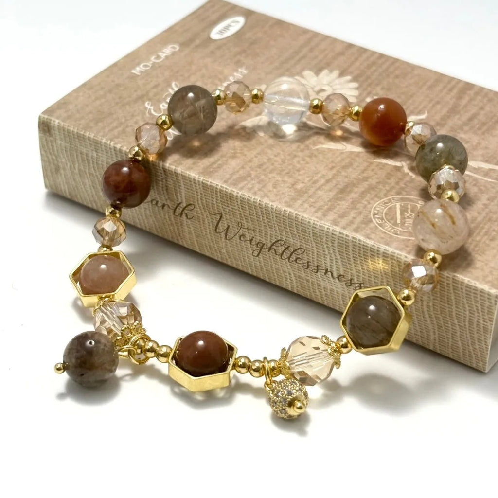 Gold crystal bracelet with 8mm beads showing hand-woven construction and traditional auspicious symbols