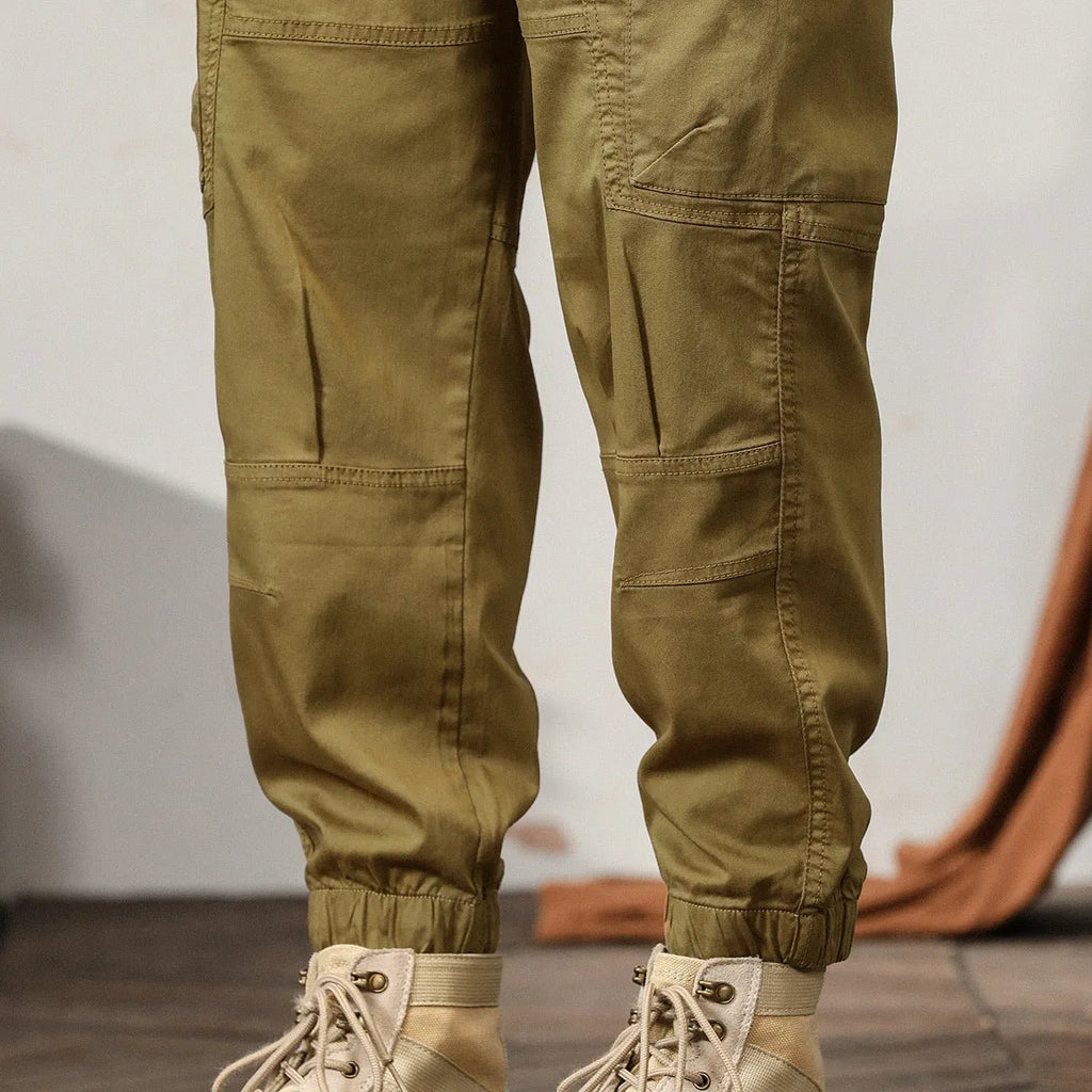 Men's cotton tapered harem trousers in black with elastic waistband and ankle band detailing