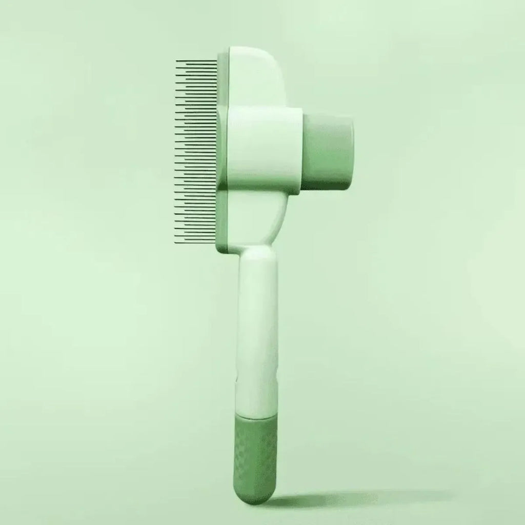 Green and yellow pet grooming brush with one-click hair removal and anti-mite cleaning bristles for dogs