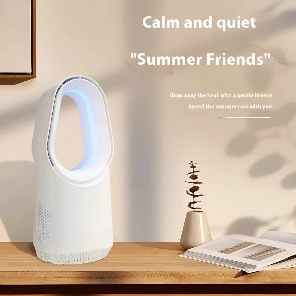 White bladeless tower fan with remote control placed on a desk next to a laptop.