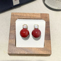 Simple zircon inlaid pearl earrings on display showing three style options
