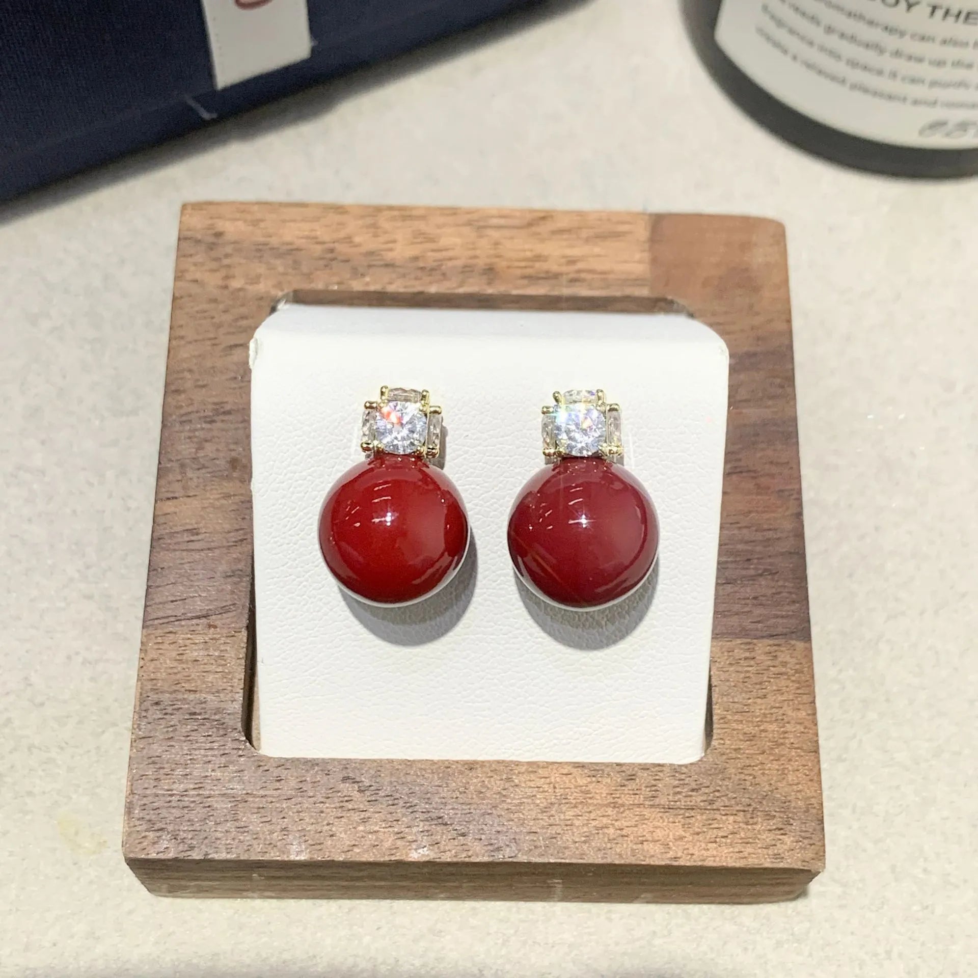Simple zircon inlaid pearl earrings on display showing three style options