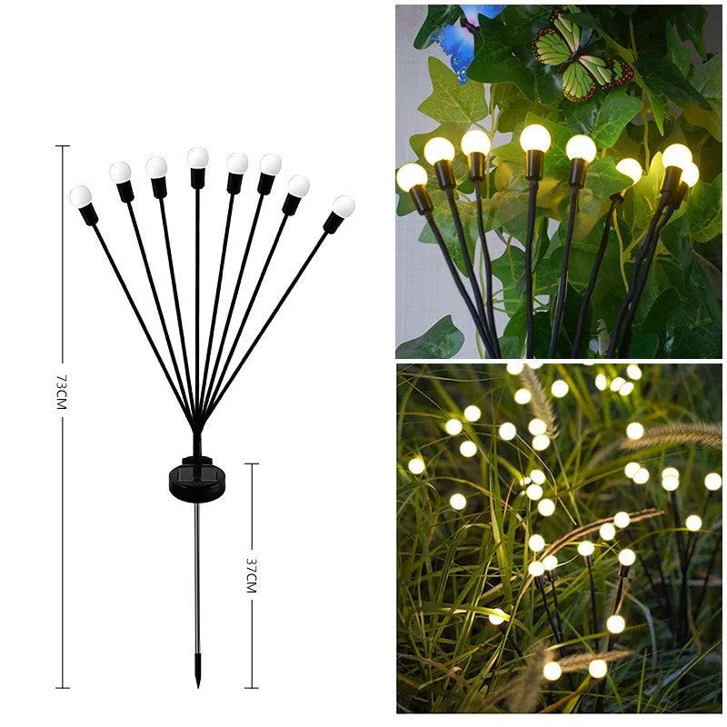 Solar-powered LED pneumatic firefly ground stake light with multiple heads on a grassy lawn.
