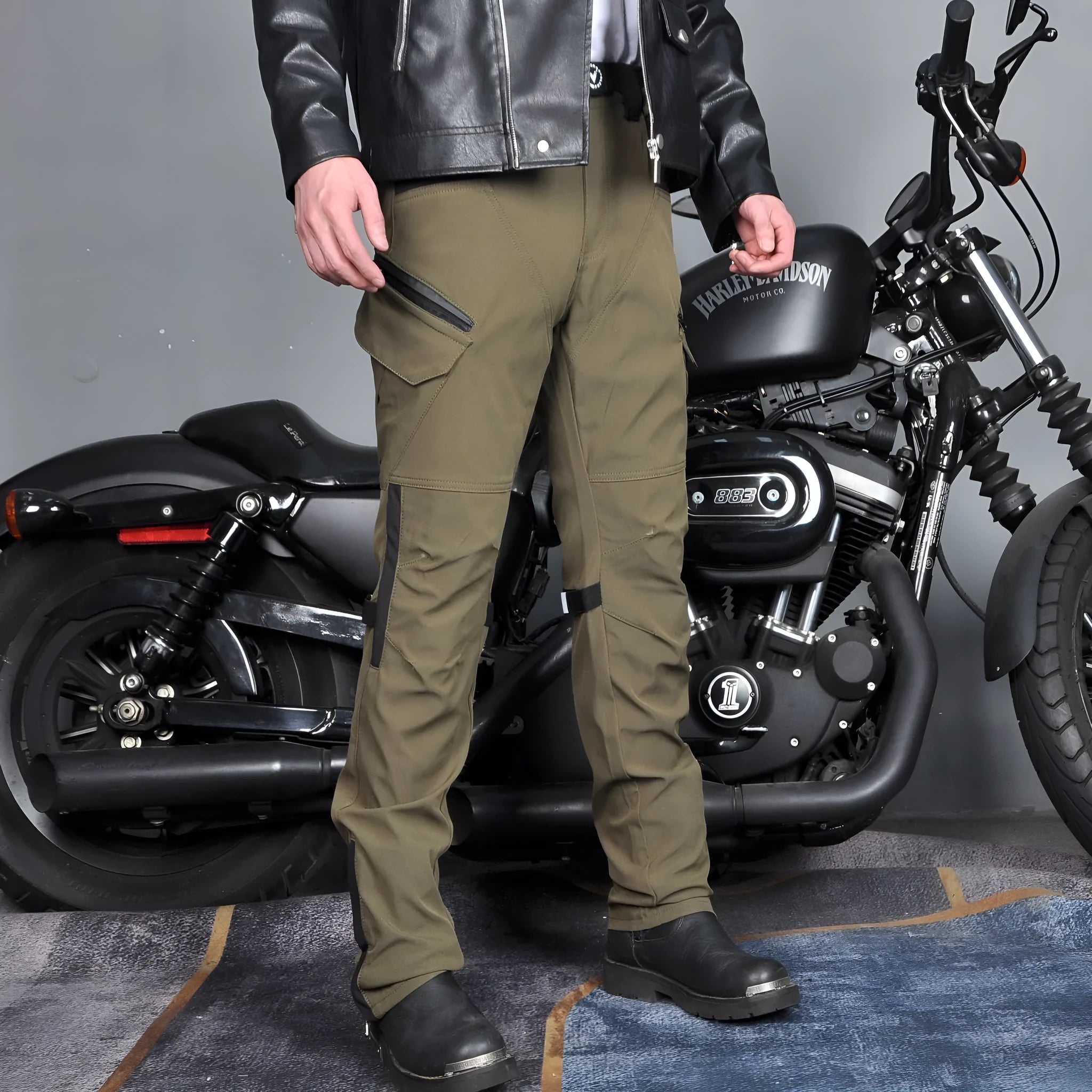 Man wearing green waterproof motorcycle trousers with belt and protective gear for cycling.