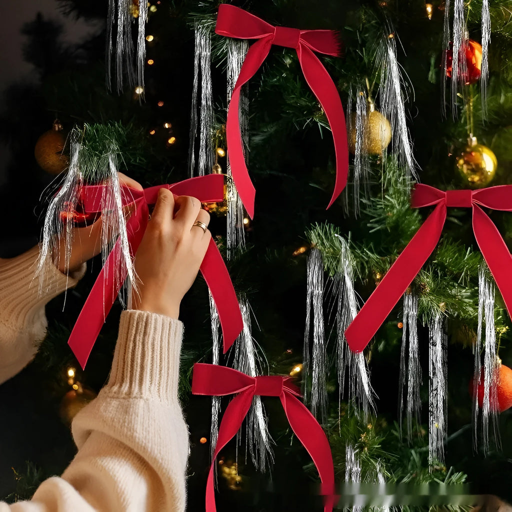 Velvet ribbon Christmas tree strap pendant decoration in a selection of colours including red and gold on a tree branch