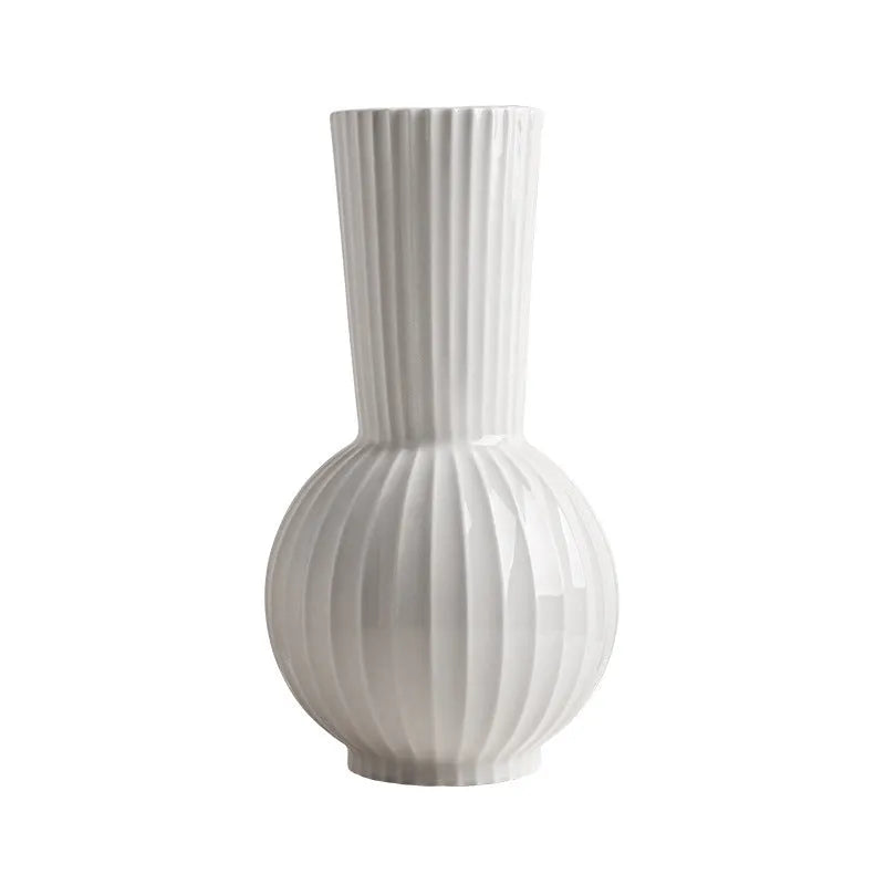 White ceramic vase with blue stripes in ball shape on wooden table