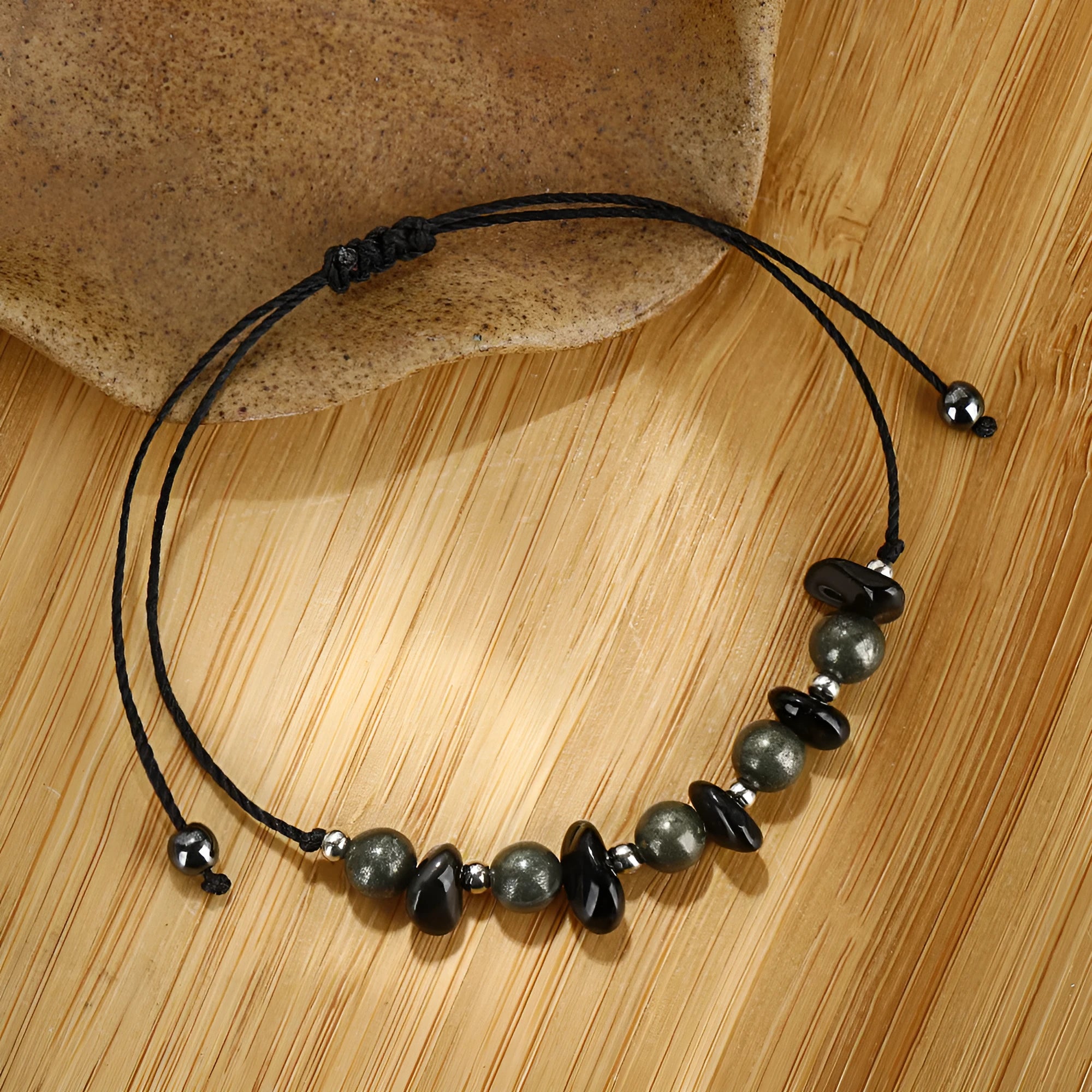 Black stone beaded bracelet with geometric garnet gravel beads and moon design element