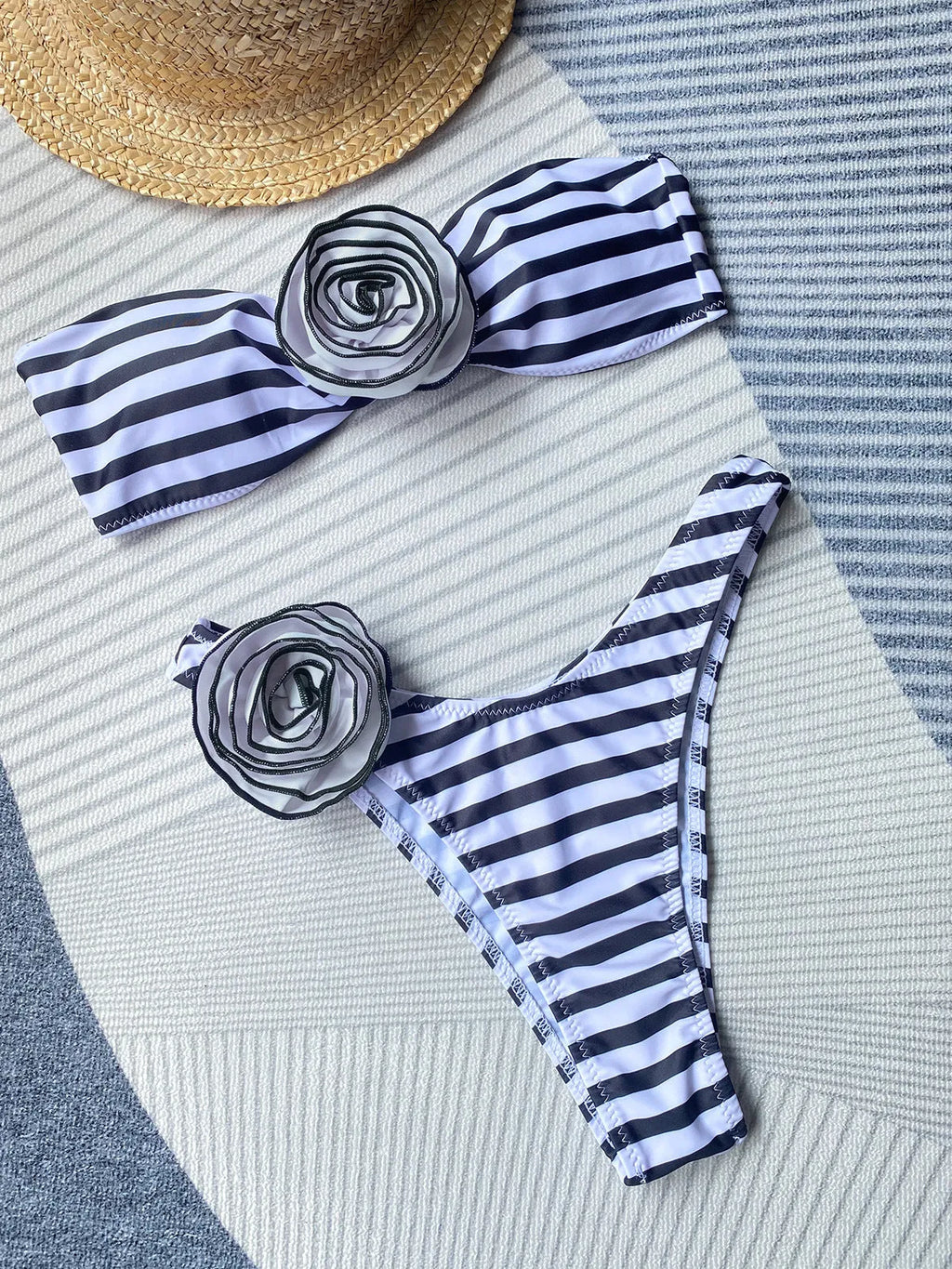Women's black cross-back bikini with floral split detail and matching shorts.
