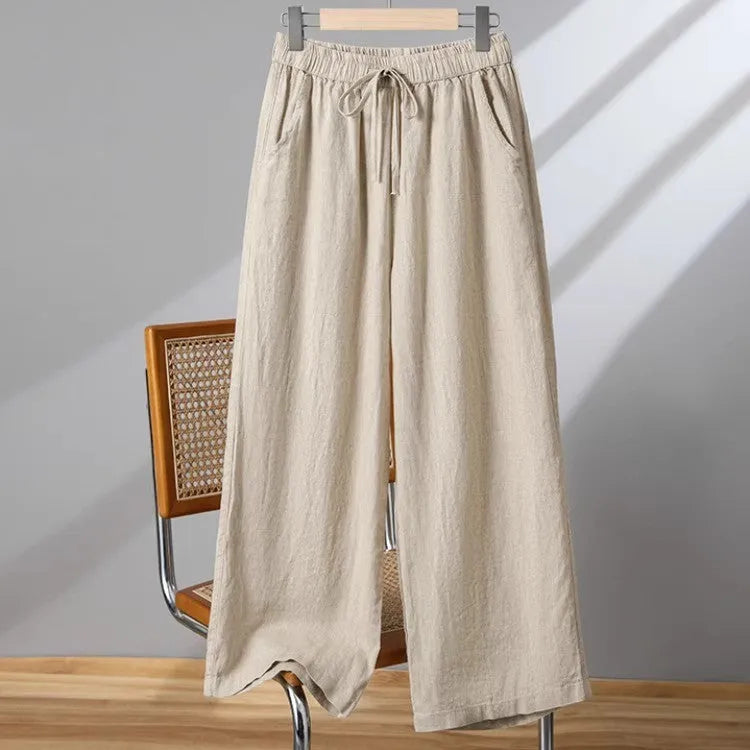 Women's straight-leg casual trousers in apricot colour with an elastic waistband and lace-up drawstring detail.
