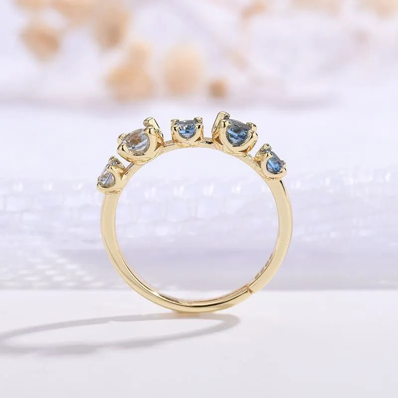 Gradient blue and white topaz multi-gemstone zircon ring with adjustable open mouth design