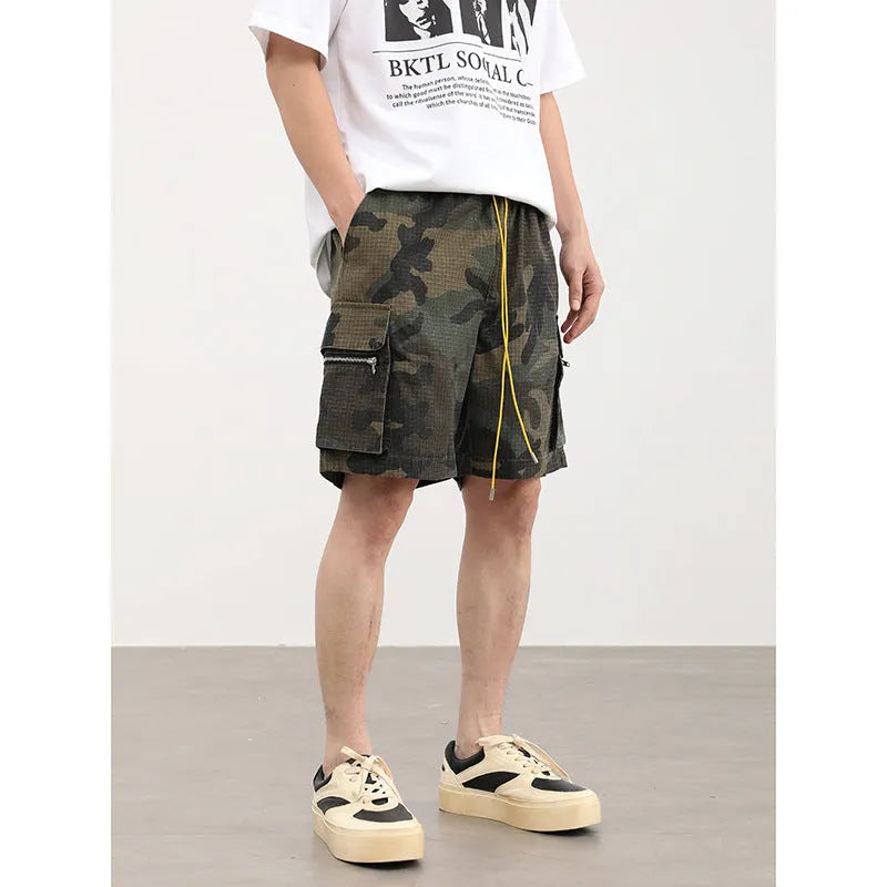 Men's camouflage cargo shorts showing multiple pockets and cropped leg length