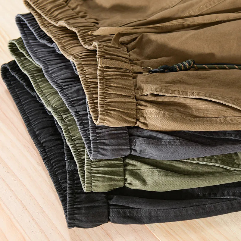 Men's cotton casual overalls in army green with a drawstring waist and tapered ankle bands.