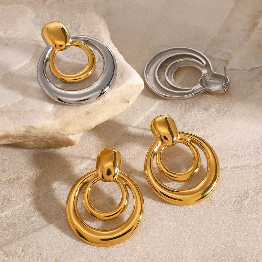 Gold-plated titanium steel hollow stud earrings with double-layer round geometry design
