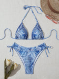 Denim blue printed women's bikini swimsuit with adjustable straps laid flat.