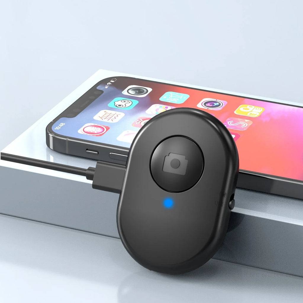 Black mobile phone tripod extended to 1.1m on a desk showing metal legs and phone mount