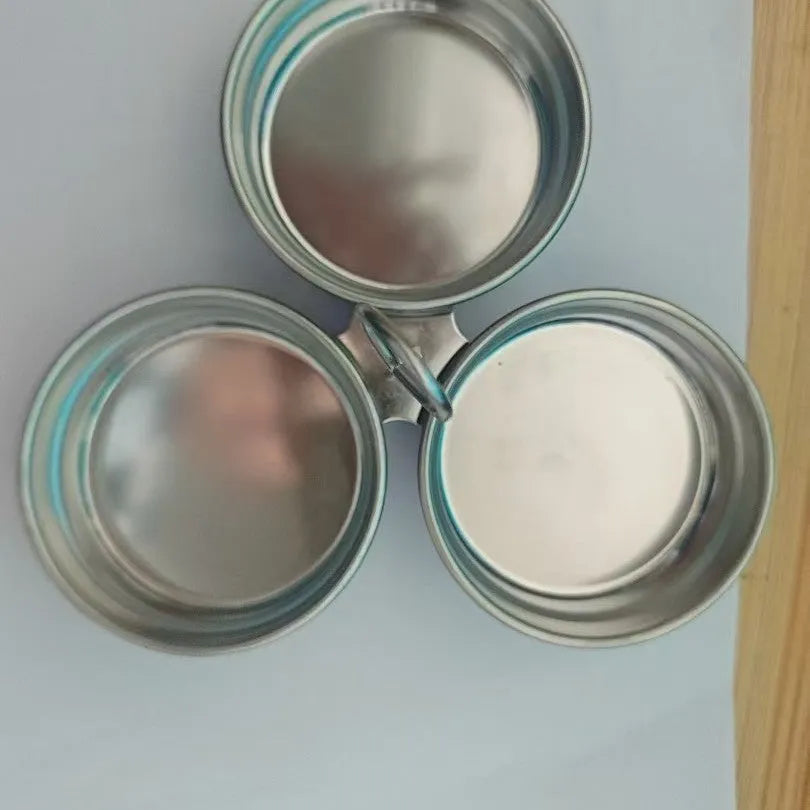Mini stainless steel egg steamer shown in heart-shaped and round designs on a kitchen counter.