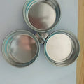 Mini stainless steel egg steamer shown in heart-shaped and round designs on a kitchen counter.