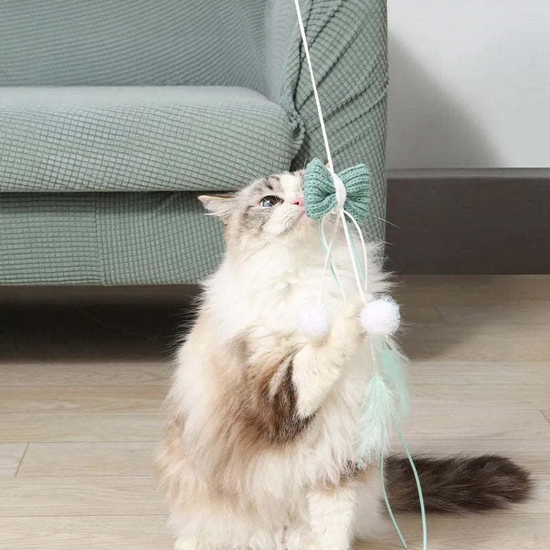 Blue cat toy wand with long pole and a bite-resistant rocket attachment decorated with feathers.