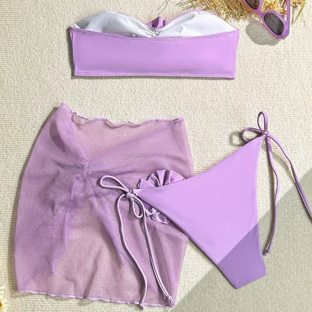 Women's pink bikini set with large 3D flower tie on tube top, matching skirt and pants.