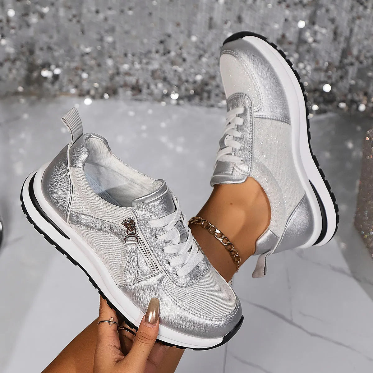 Gold women's flat sole lace-up pumps with round toe on a white background.