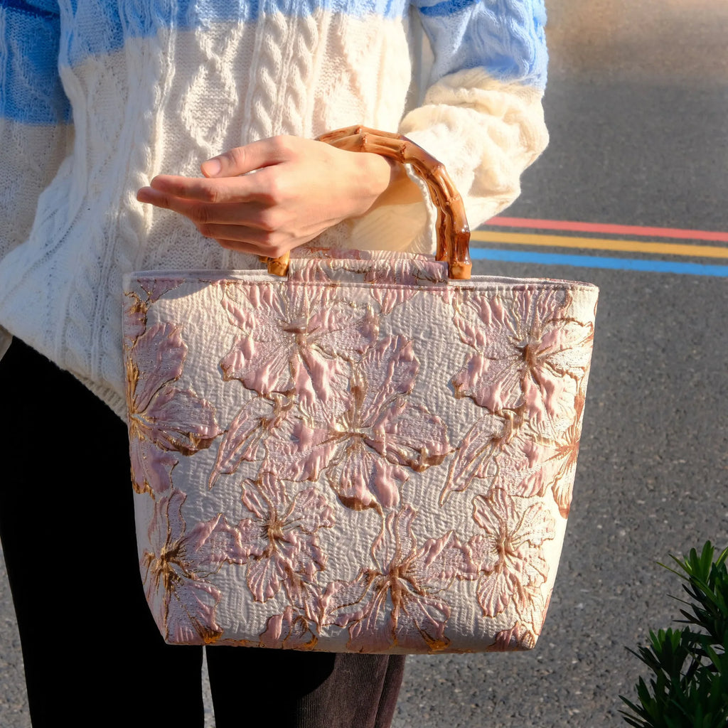 Light blue women's canvas shoulder bag with gold bronzing flower detailing showing horizontal square shape