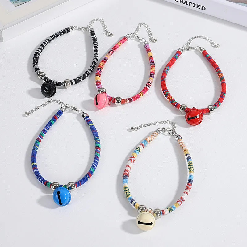Ethnic style pet collar with bell in multiple colours showing adjustable fastening
